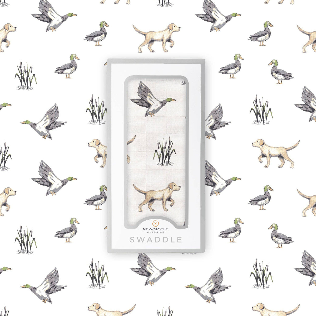 A packaged swaddle blanket with a hunting-themed print of ducks, dogs, and reeds, shown in its clear window box packaging against a matching patterned background.