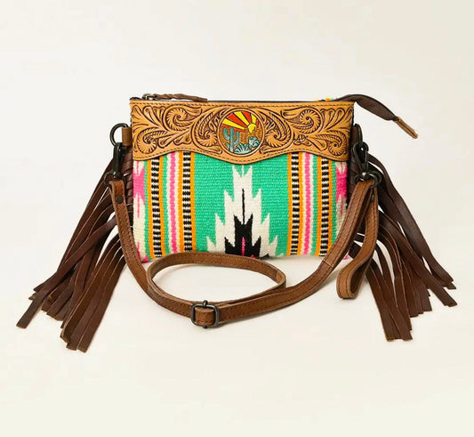 Handbag with decorative strap and fringes on a white background