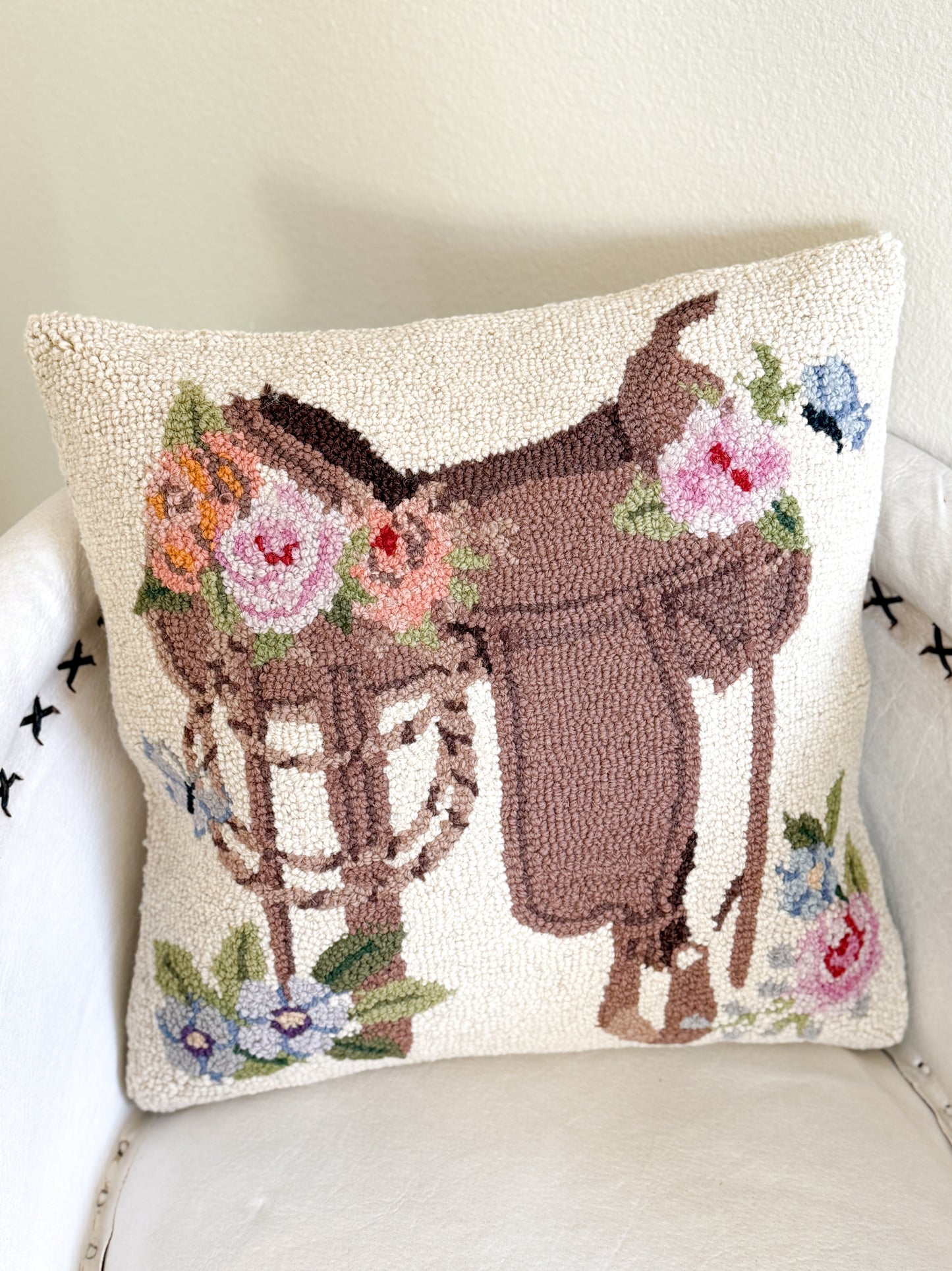 Wool floral saddle pillow with western cowgirl design