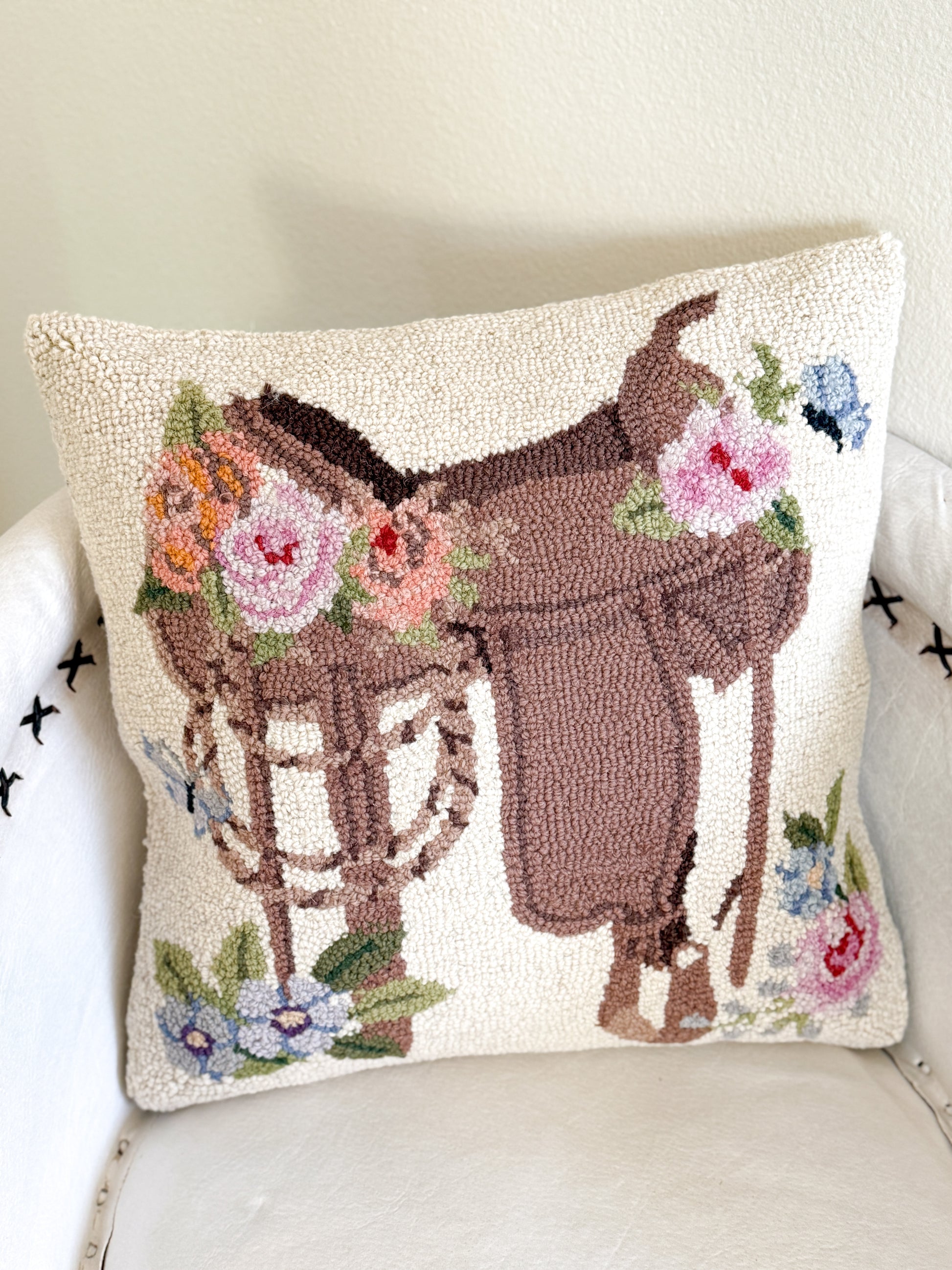 Wool floral saddle pillow with western cowgirl design