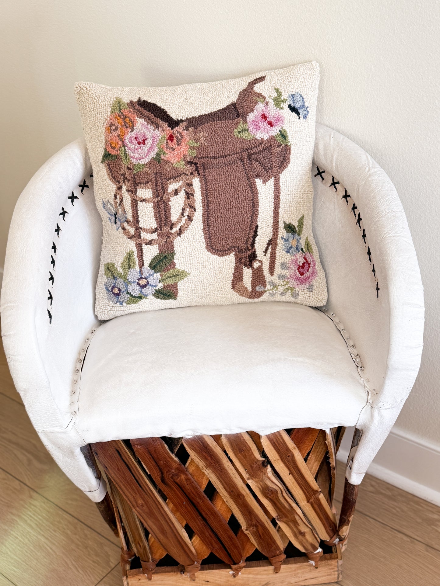 Wool floral saddle pillow with western cowgirl design