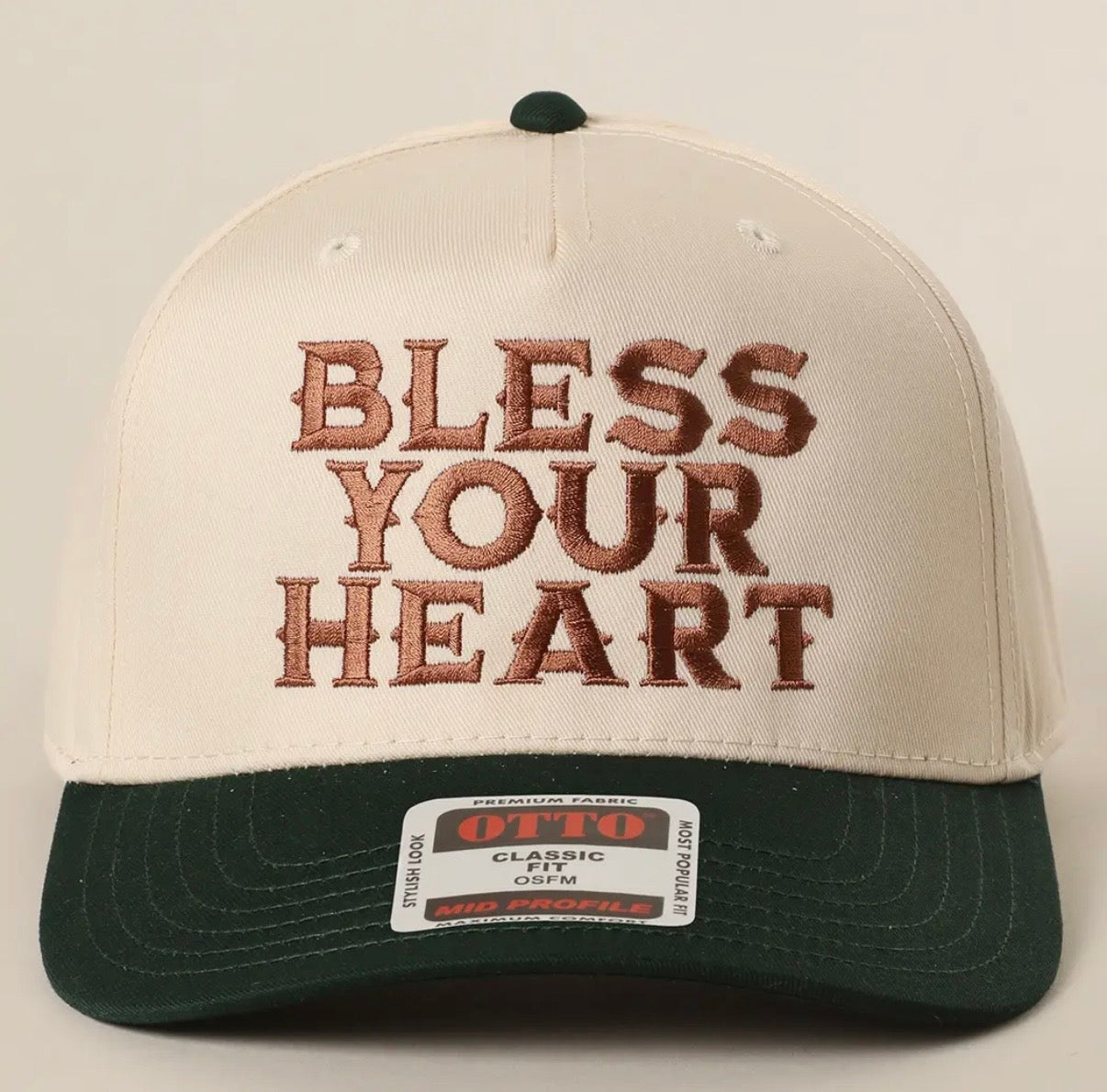 Cap with 'Bless Your Heart' text on a cream color hat with Dark Green brim