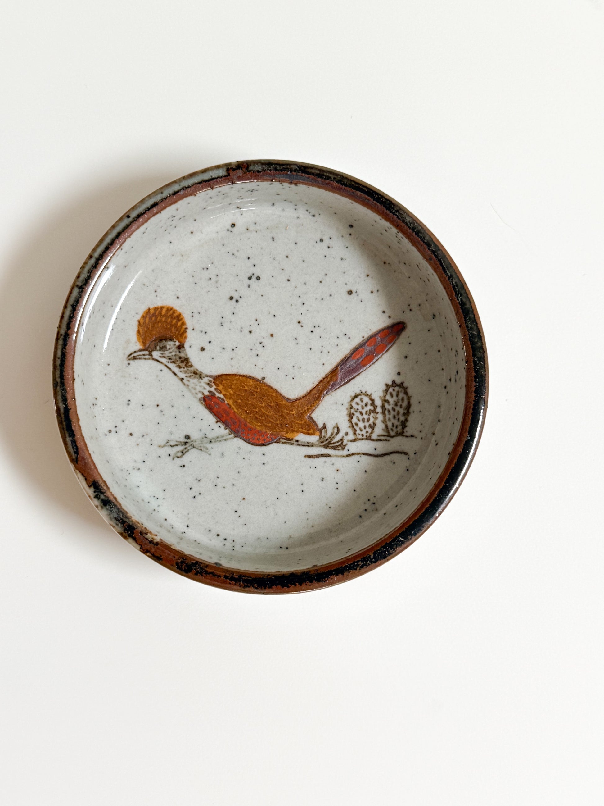 Ceramic plate with a bird design on a white background