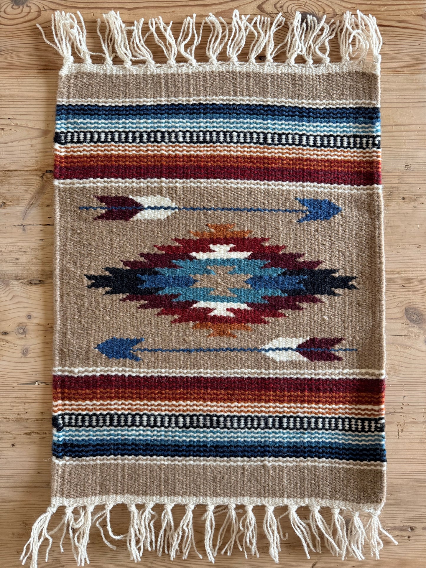 Southwestern wool table mat with arrow pattern and fringe