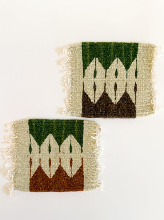 Two woven southwestern coasters with geometric pattern on a white background