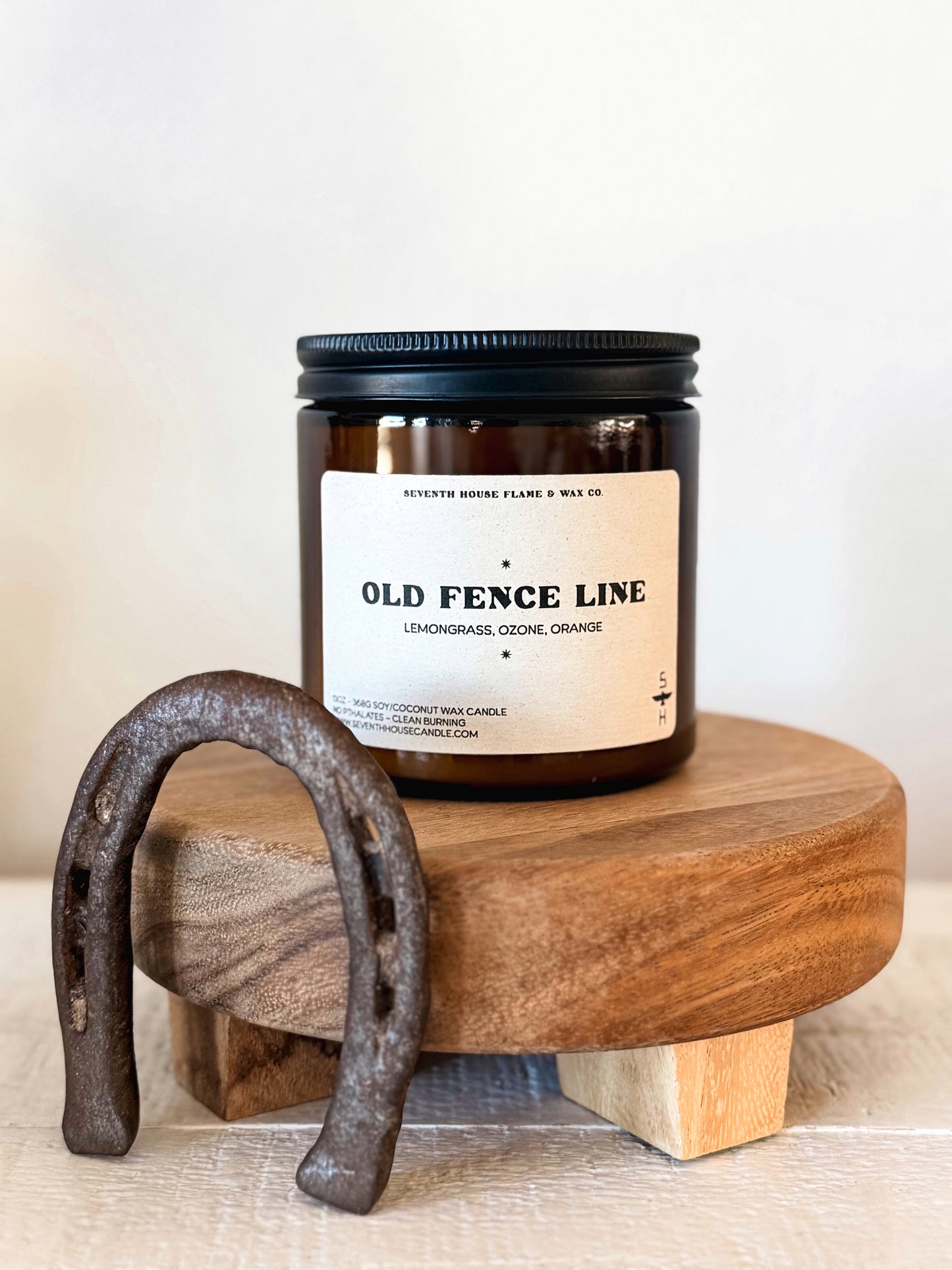 Western soy candle in amber jar styled with rustic wood and horseshoe