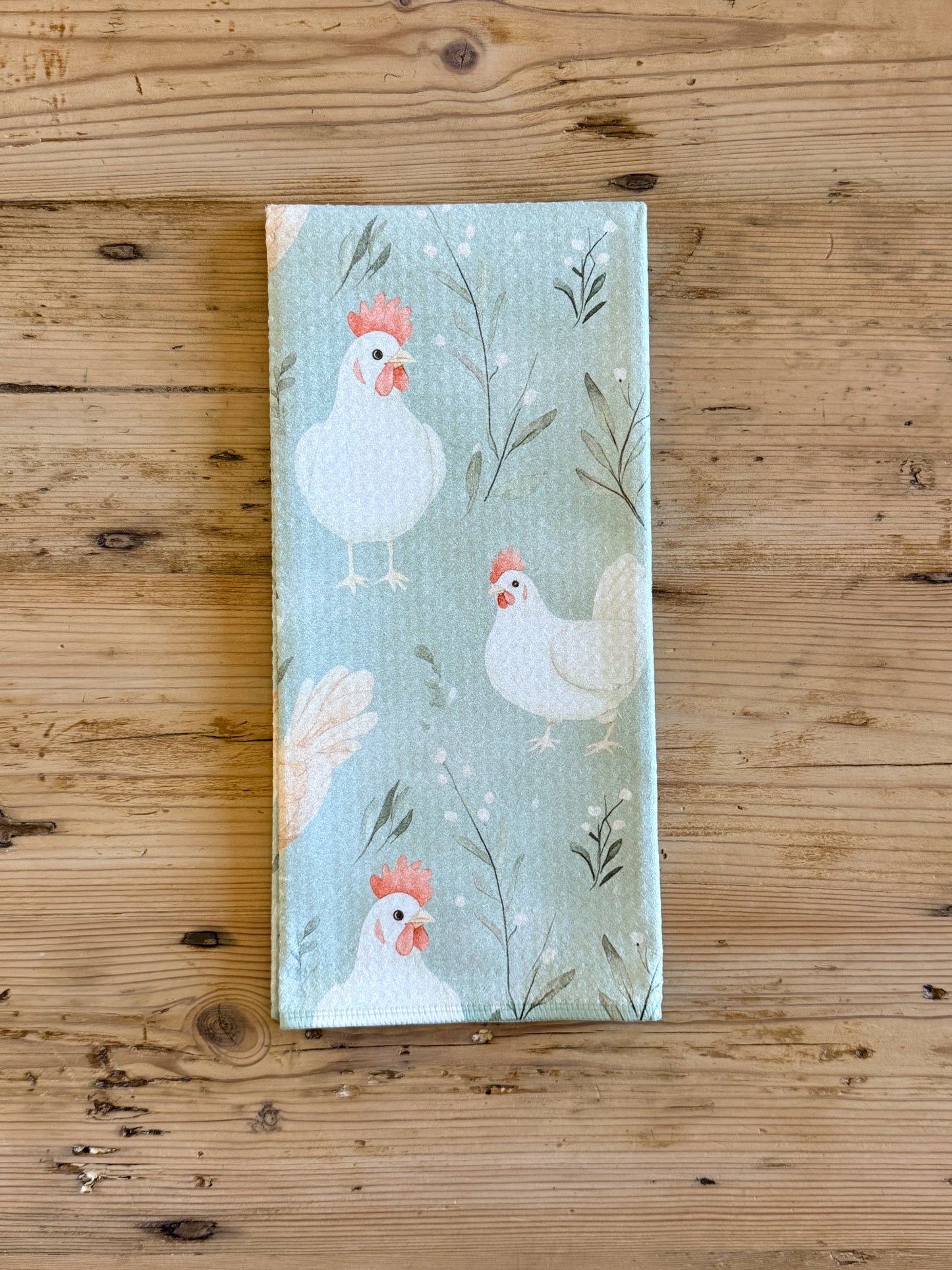 Sage green chicken kitchen towel with white and tan hens and botanical print
