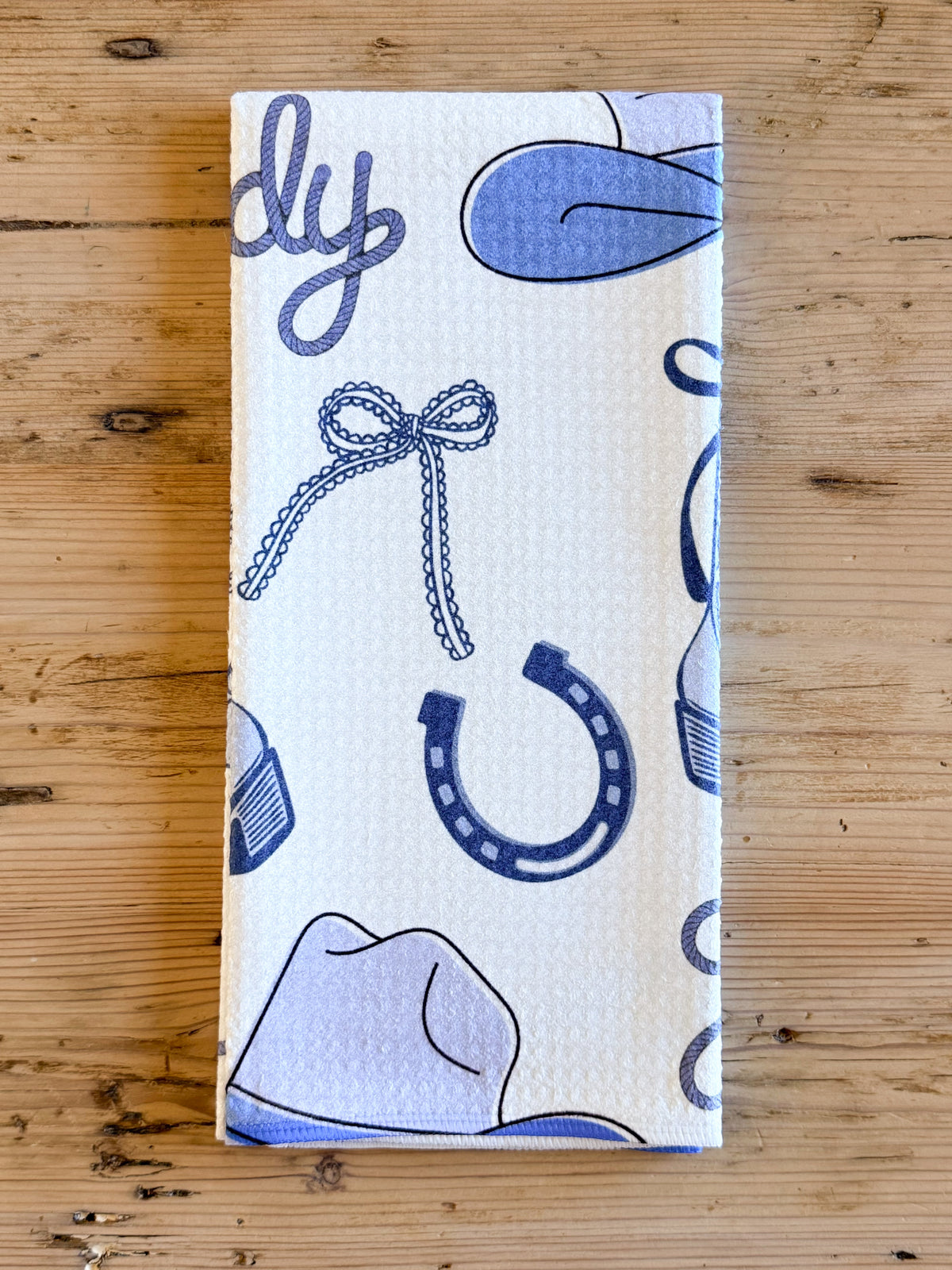 Howdy Western kitchen towel with blue cowboy boots hats horseshoes and cactus